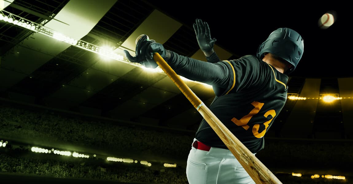 Baseball athlete at bat under stadium lights